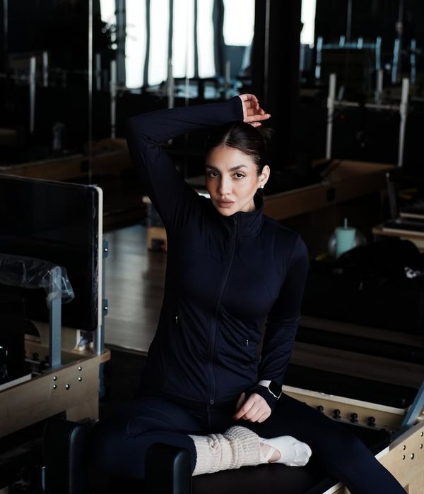 Man performing coordination exercises in a modern dark studio gym.